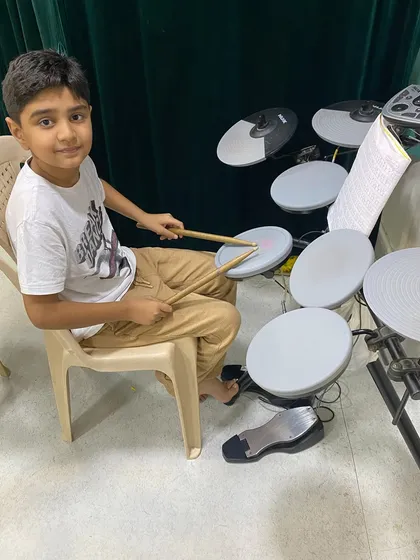 This young student is getting started with our drumset classes. We provide a supportive environment for kids to explore rhythm and build confidence on the electronic drums.
