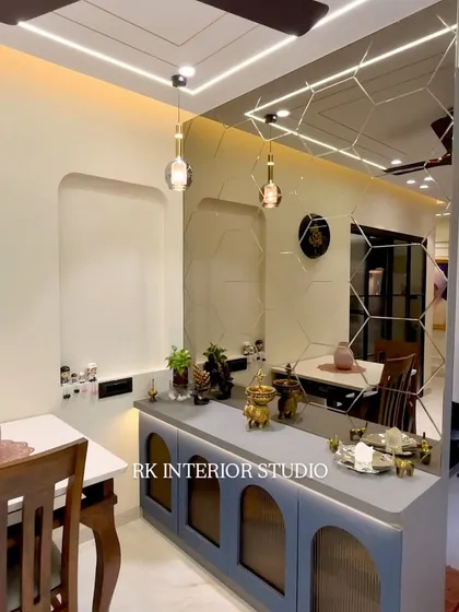 A stylish crockery unit with fluted glass doors and a large, geometric mirror wall. This combination not only provides storage but also acts as a stunning decorative feature in the dining area.