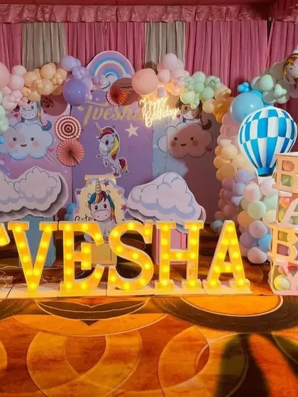 I love creating dreamy, pastel-themed parties. This first birthday setup for Tvesha features a whimsical unicorn and hot air balloon theme, complete with custom backdrops, cloud props, light-up marquee letters, and a full pastel balloon arch.