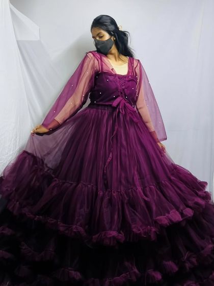 This is a deep wine-colored version of my popular ruffled tulle gown. It features sheer, dotted sleeves and a full, layered skirt for a dramatic effect.