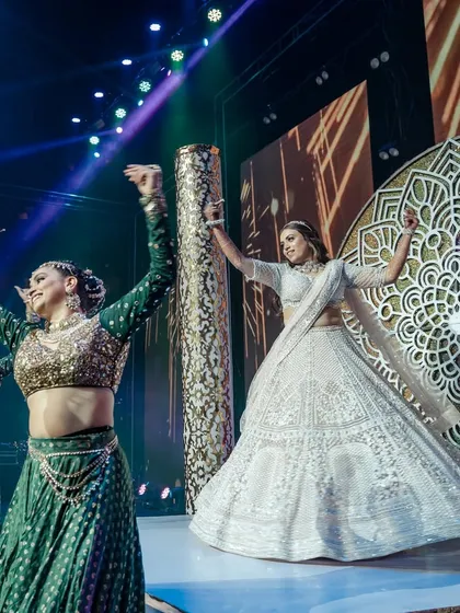 A powerful shot of our bride owning the stage during her surprise solo performance. We worked with her through multiple practice sessions to ensure she was confident and flawless for her big moment.