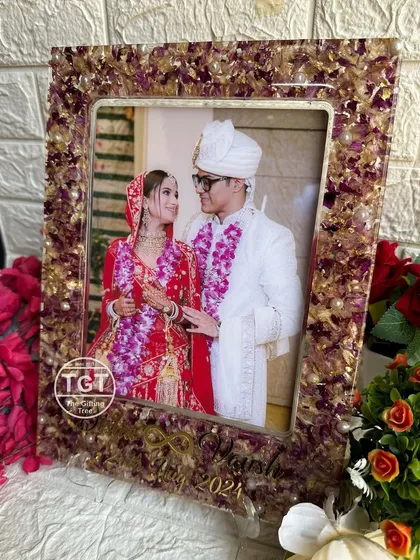 Another view of the frame on its stand, showing the intricate details of the floral border.
