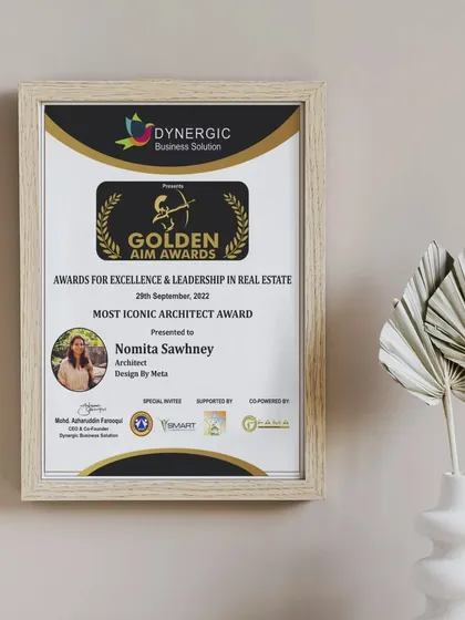 A framed display of our Golden Aim Award for "Most Iconic Architect." This serves as a daily reminder in our studio of the high standards we strive to uphold in every design.