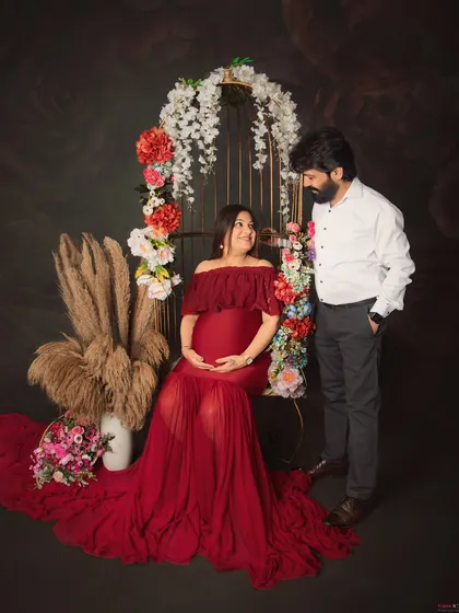 Feeling like a goddess in red. This maternity session was all about celebrating the power and beauty of motherhood with a stunning floral birdcage prop and a flowing gown to highlight the beautiful baby bump.