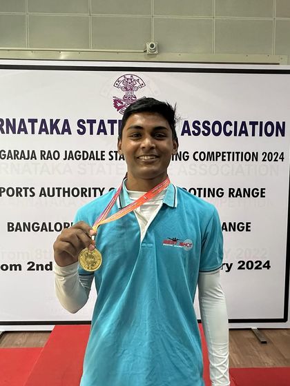 Ronak, a gold medalist from the Air Rifle Men's team, posing with his medal.