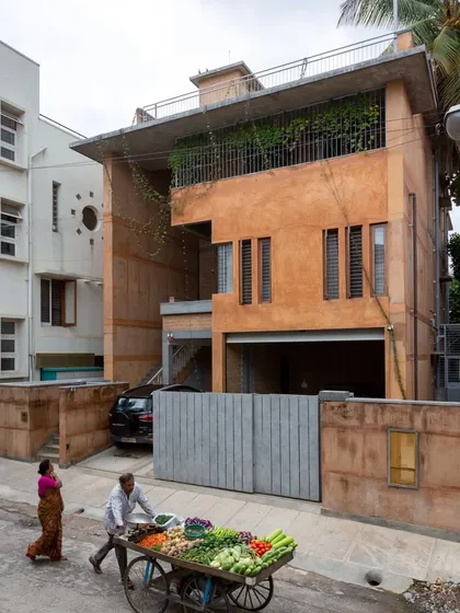 This is the exterior of a residence we designed in a dense Bangalore neighborhood. We used earth from the site itself and debris from the old, demolished house to construct the new walls, creating a structure that is both modern and deeply rooted in its own history and place.