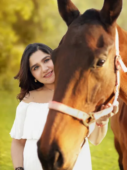 A beautiful portrait of a mother-to-be with her equine friend. The focus is on her happy expression and the gentle nature of the horse, making for a truly special memory.