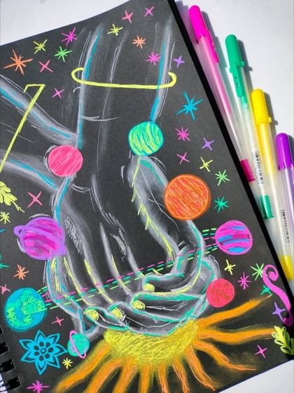 "Soulful Universe." A creative doodle on black paper using Gelly Roll pens to create a glowing effect.