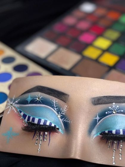 Winter wonderland eyes. This is a close-up of my creative eye art, featuring snowflakes, stars, and dripping icicles, all created with eyeshadow and liner.