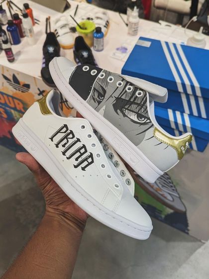 A custom Adidas Stan Smith I painted live at an event, featuring a manga-style portrait. This is an example of the quick, clean work I can do on the spot.
