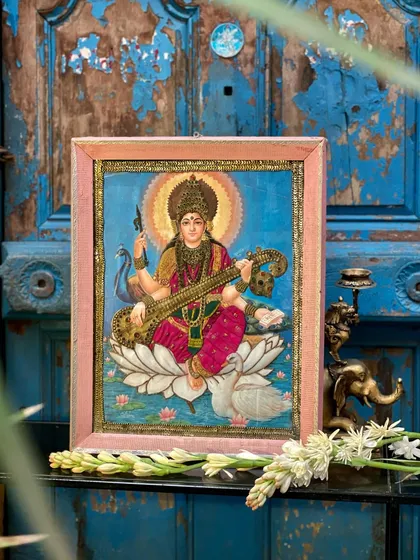 This is a cloth oleograph of Goddess Saraswati, a beautiful print by Raja Ravi Varma that we’ve reworked on cloth with delicate embroidery. It adds texture and a three-dimensional quality, giving new life to a classic piece of art.