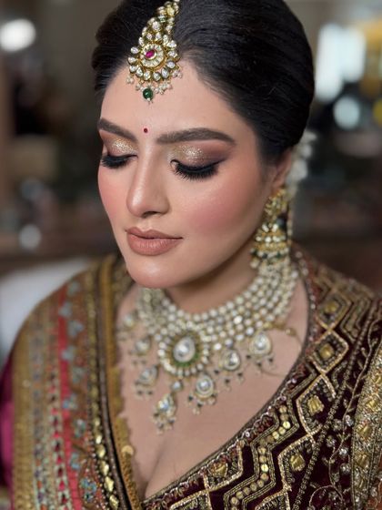 A close-up of this gorgeous bridal makeup. We created a soft, bronze smokey eye with a nude lip, letting her beautiful features and stunning jewelry take center stage.