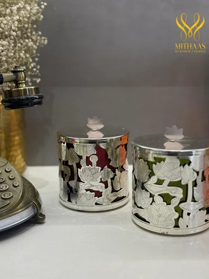 These silver jars with a delicate lotus cutout design are a symbol of luxury and grace. I fill them with my finest confections, and the jars themselves become a beautiful decor piece for your home.