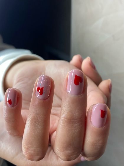 A simple yet sweet Valentine's or romantic-themed design featuring small red hearts on a natural pink base. Perfect for short nails.