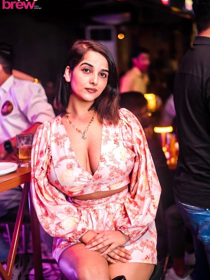 A guest enjoying her time at a high-top table. We ensure a comfortable and stylish environment for all attendees.