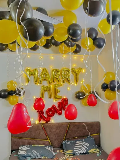 Another view of the 'Marry Me' proposal decoration, showing the 'Love' foil balloon and the full effect of the ceiling decor.