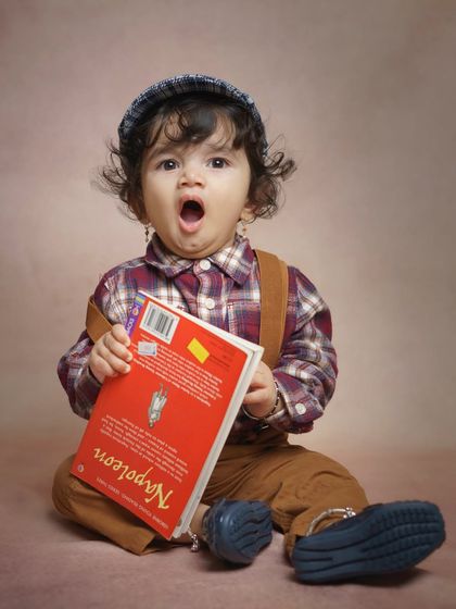 A big yawn from a little reader! Candid moments like these are often the most cherished, showing the real, unscripted parts of a child's day, even during a styled shoot.