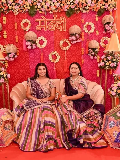 The bride and her mother posing in front of the vibrant mehendi stage, a beautiful memory from the 'Piyu ki Shaadi' celebrations.