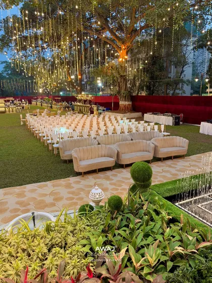 A wide view of the outdoor seating arrangement, showing the combination of sofas and chairs to accommodate guests comfortably.
