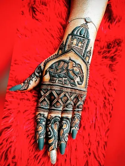 A bold and beautiful back-hand design. It features a grand elephant under an archway, topped with a temple dome, making it a statement piece for any special occasion.