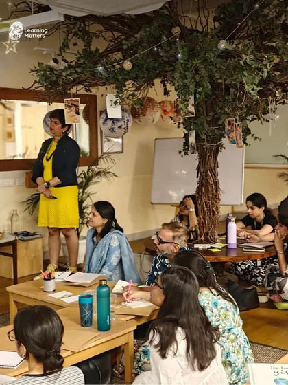 An educator presents to an engaged group during a professional development workshop. Our sessions are interactive, encouraging discussion and shared learning among participants in a collaborative and supportive environment.