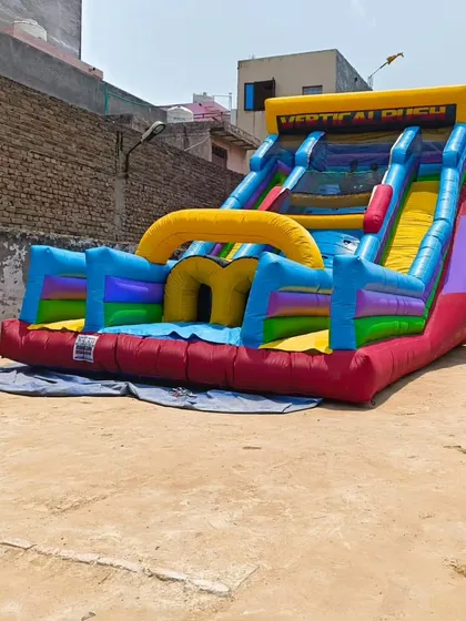 This "Vertical Rush" style inflatable is a dual-lane slide with a climbing challenge in the middle, designed for competitive races.