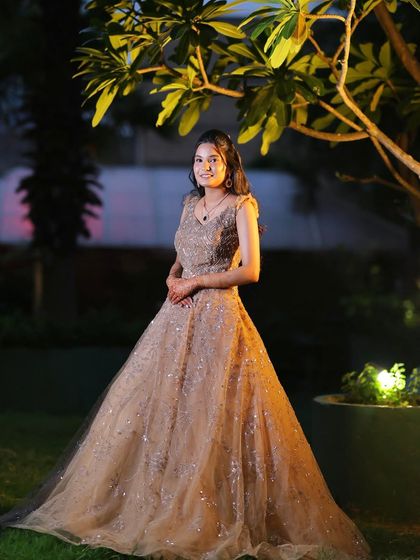 A full-length shot showing the entire gown and the beautiful outdoor lighting.