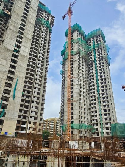 Another view from the construction site of the Mumbai residential township, highlighting the structural framework and crane operations.