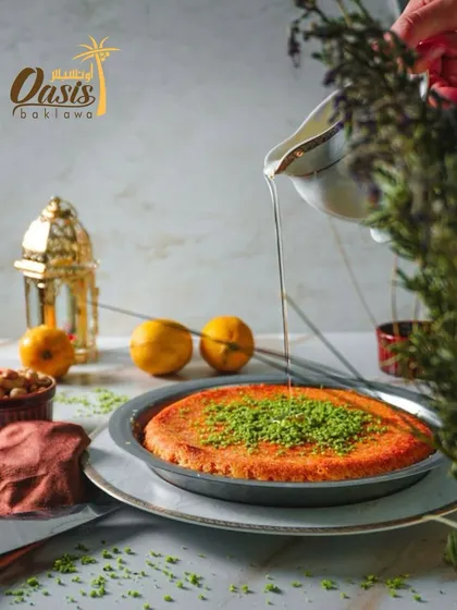 A beautifully styled shot of our authentic Kunafa, ready to be served for Eid. The festive lanterns in the background add to the celebratory mood.
