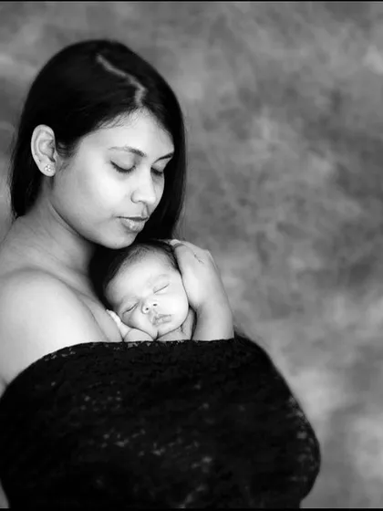 As a mother, I know this feeling so well. This classic black and white portrait captures the quiet, powerful bond between a mother and her newborn. It is an intimate, soulful moment that speaks directly to the heart, preserved as a piece of fine art.