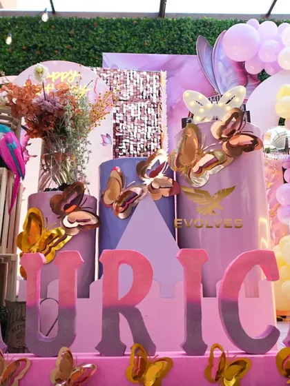 A close-up of the butterfly-themed decor for Aurica's birthday, showing the custom 3D name lettering, cake stands, and butterfly embellishments that make the theme feel complete.