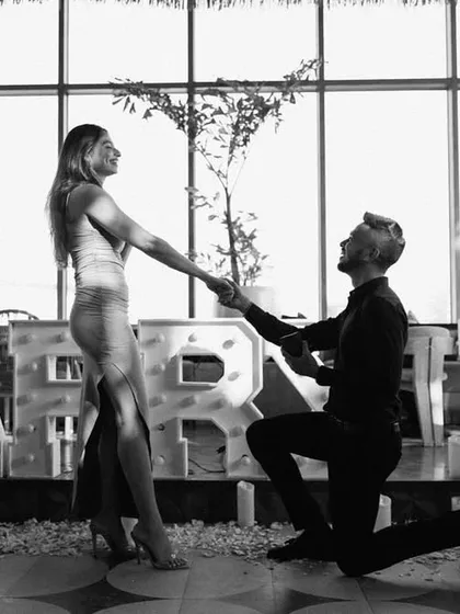 Capturing the moment it all becomes real. Behind the couple is our "MARRY ME" marquee letter setup, providing a bold and beautiful backdrop for their unforgettable proposal photos.