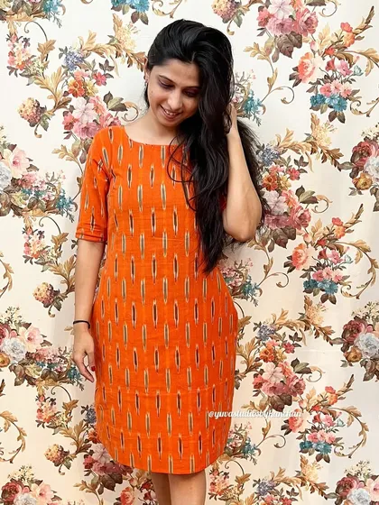 A simple yet stunning straight-fit dress in a vibrant orange Ikat. It's an easy-to-wear piece that's perfect for work or a casual day, and it comes with pockets.