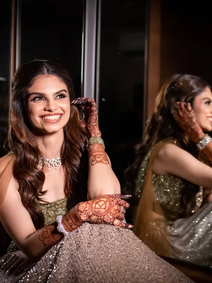 A reflective moment during her engagement day. The makeup was designed to look flawless from every angle, with a focus on luminous skin and a bright, happy smile.