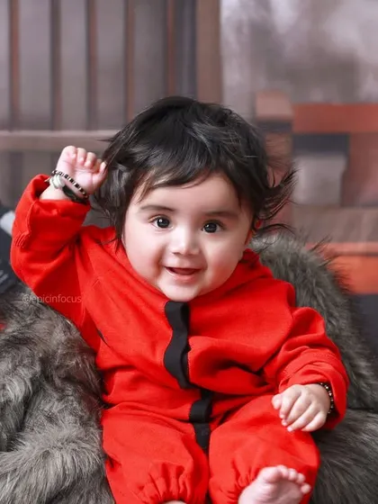 A close-up of the star of the 'Money Heist' shoot, looking adorable in the iconic red jumpsuit and surrounded by Dali masks.