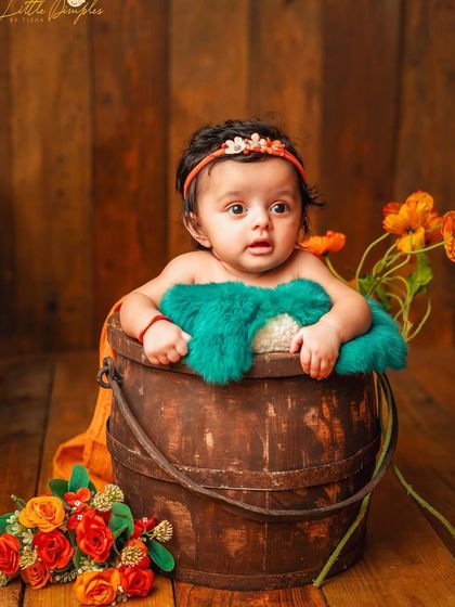 Peeking out of a rustic wooden bucket. I love using simple props to create adorable and memorable portraits for sitter sessions.