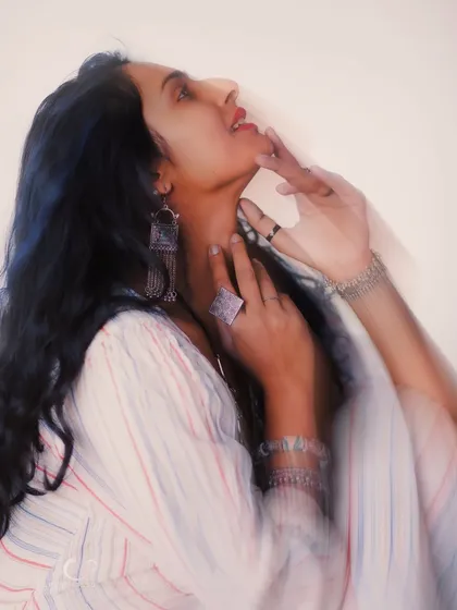 Using motion blur to capture the essence of a fleeting feeling. This artistic portrait is less about a sharp image and more about conveying a dreamy, ethereal mood.