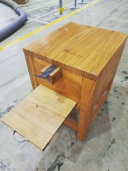 The coconut grater with its pull-out tray extended, a feature designed for easy collection.