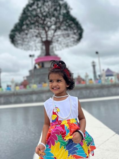 A young traveler enjoying the beauty of the Mandaragiri temple complex.