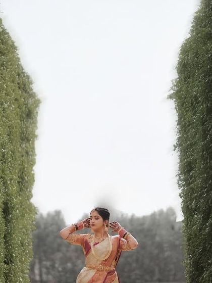 An artistic shot of the bride standing between two tall hedges, creating a powerful and dramatic composition.