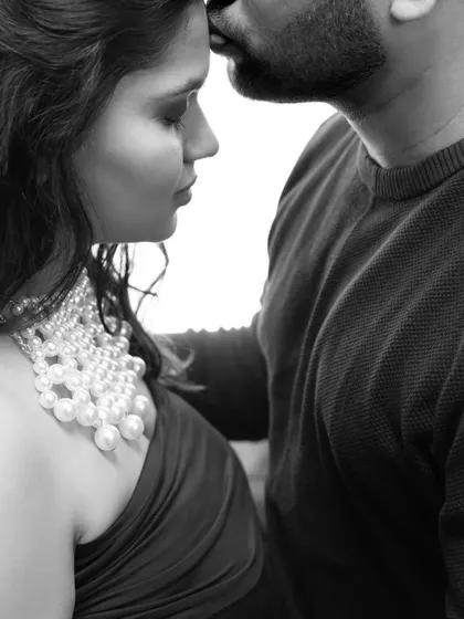 A tender kiss on the forehead is a promise of protection and love. This close up, black and white shot focuses on the intimacy and emotion of the moment, stripping away all distractions to show pure connection.