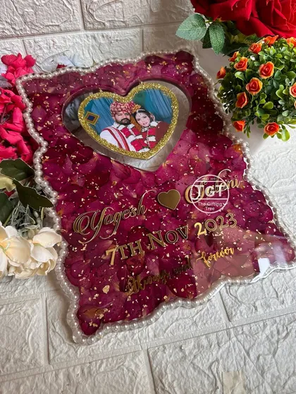 This shot captures the glossy finish of the resin and the intricate details of the preserved petals and gold flakes.