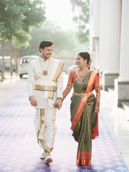 The couple walking hand-in-hand after their ceremony, a perfect candid shot full of happiness.