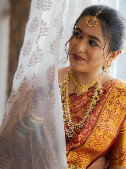 A candid moment of the bride looking away, her soft makeup beautifully captured.