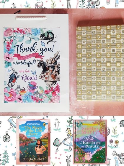 The complete Alice in Wonderland gift set, showing the themed paper bag and the beautifully wrapped storybooks.