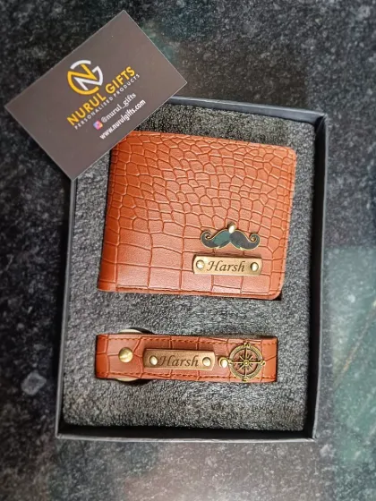A matching set of a crocodile leather wallet and keychain, both personalized for 'Harsh' with a mustache and compass charm.