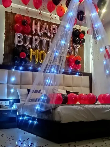 A duplicate image of a birthday room decoration with a canopy and blue fairy lights.