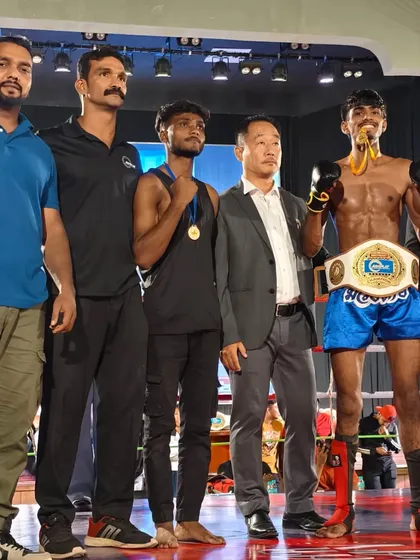 The team of coaches and officials with the new champion. It takes a village to build a fighter.
