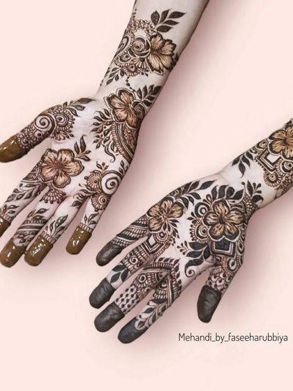 A different angle of the hibiscus floral design, showing how it flows from the wrist to the fingers.