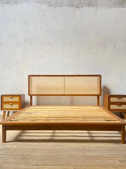 One of my most popular designs, this mid-century modern bed frame is made from solid teak with a caned headboard. It's shown here with two matching bedside tables that feature the same rounded edges and tapered legs.